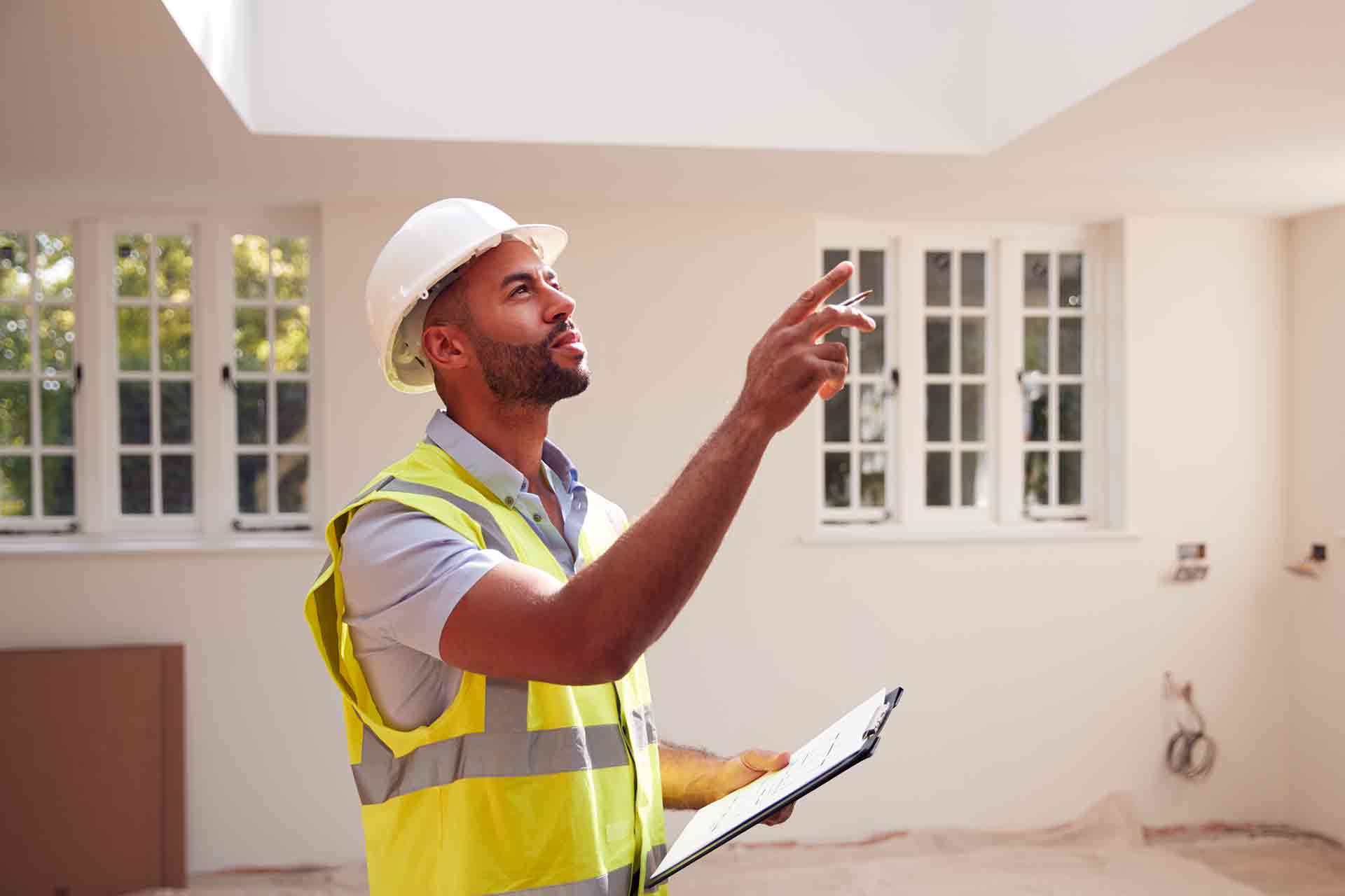 Third Party Wall Surveyors Colchester reviewing plans between two parties during a dispute